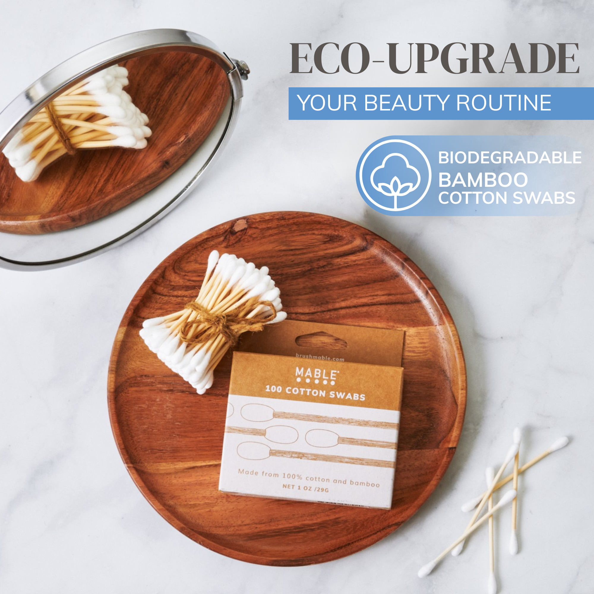 The best plastic-free cotton swabs by MABLE, cotton swabs on a white marble background with words eco-upgrade your beauty routine and biodegradable bamboo cotton swabs