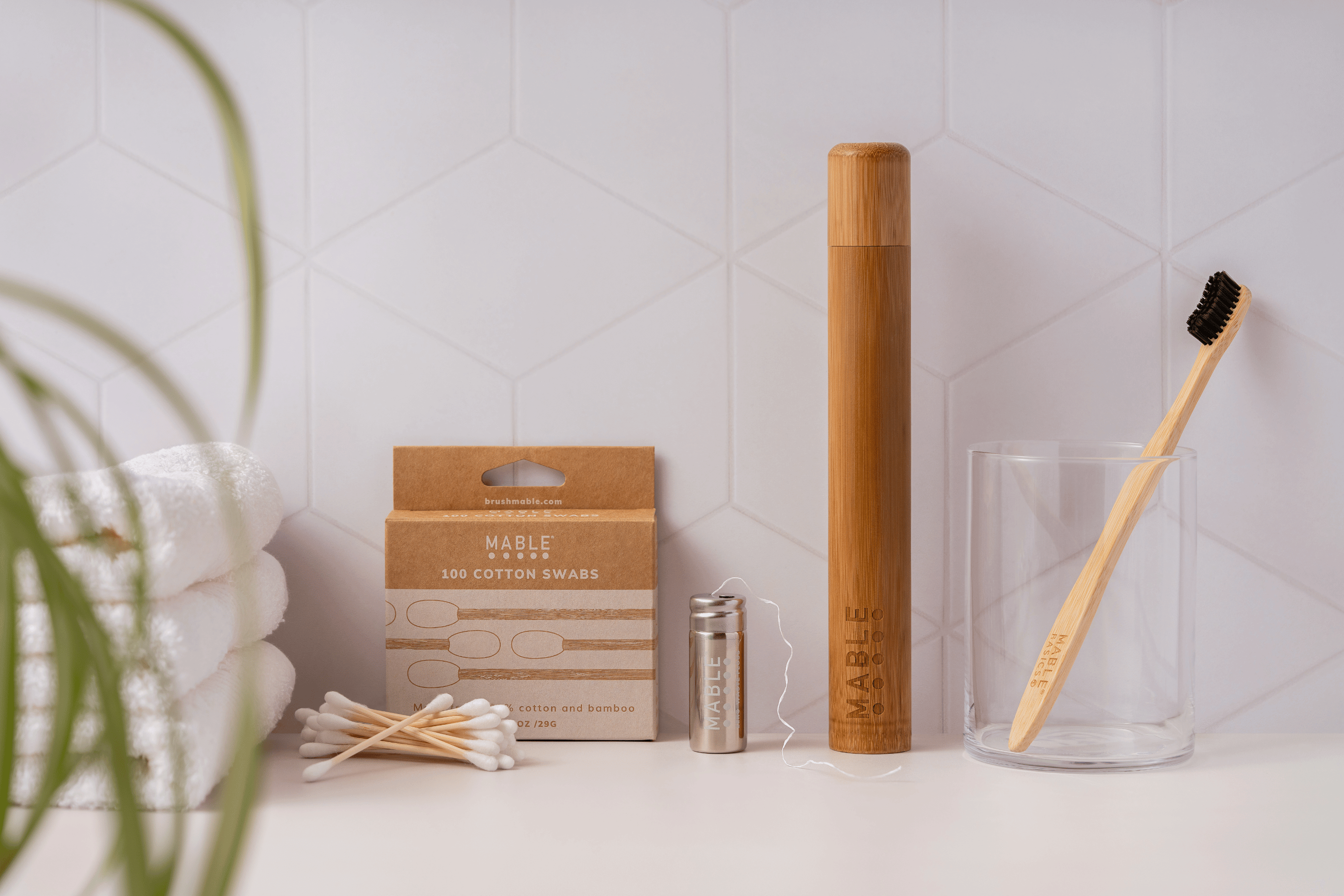 MABLE eco friendly bathroom products including MABLE basics toothbrush, MABLE bamboo toothbrush travel case, MABLE dental Floss container with compostable dental floss, compostable MABLE cotton Swabs
