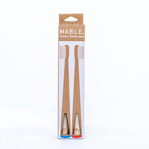 MABLE® Two pack, bamboo toothbrushes. Pack ready tu use, store ready for display and/or to hang. Recyclable packaging made from cardboard, zero plastic packaging. 2 pack includes blue and red toothbrushes.