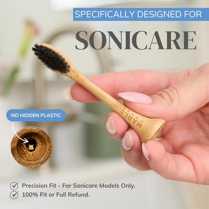 Bamboo electric toothbrush heads specifically designed for Phillips sonicare toothbrushes mans hand holding the best eco-friendly head showing no hidden plastic