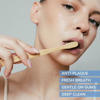 Person brushing teeth with a MABLE bamboo toothbrush against a neutral background with brush benefits highlighted like anti-plaque fresh breath gentle on gums and deep clean