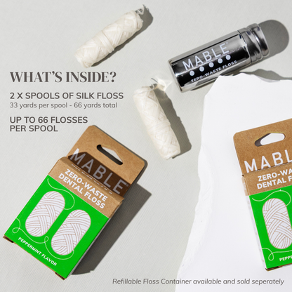 Mable dental floss packaging with silk floss on a light gray background explaining and showing that two silk spools come in each two pack silk refill pack, each floss spool is 33 yards long and can do up to 66 flosses