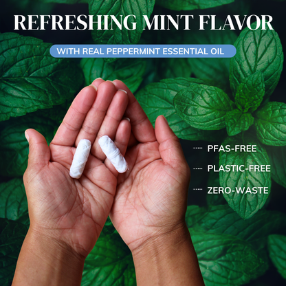 MABLE silk dental floss refills being held by a womans hand on a mint green backdrop displaying mint leaves with the words refreshing mint flavor and made with real peppermint essential oil, PFAS-free plastic free and zero-waste