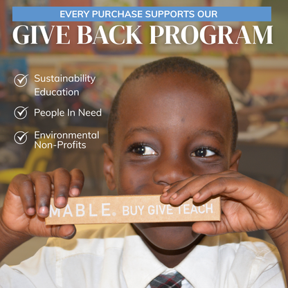 Child holding a a bamboo toothbrush package with 'MABLE. BUY GIVE TEACH' in an educational setting, with text about a give back program.